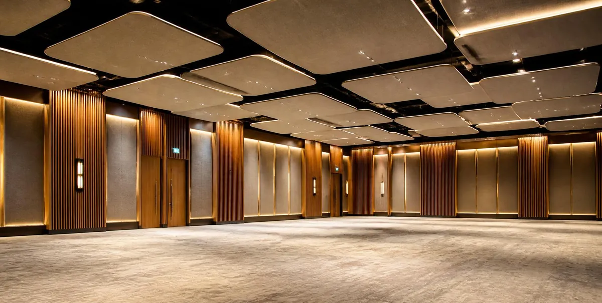 Hotel ballroom with suspended acoustic ceiling clouds, timber slat wall panels and fabric-wrapped wall panels